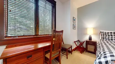 a bedroom with a desk and a bed and a window at Timbers 5 4-Bedroom Townhouse Townhouse in Mammoth Lakes