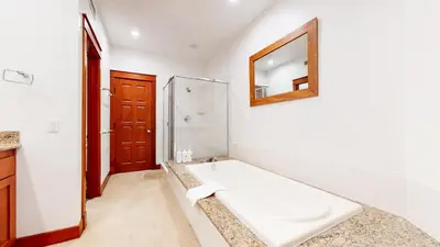 a bathroom with a white tub and a mirror at Timbers 5 4-Bedroom Townhouse Townhouse in Mammoth Lakes