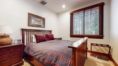 a bedroom with a bed and a dresser and a window at Timbers 5 4-Bedroom Townhouse Townhouse in Mammoth Lakes