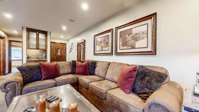 a living room with a brown leather couch at Snowcreek 269 Condo in Mammoth Lakes