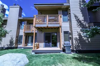 a house with a deck on the side of it at Snowcreek 269 Condo in Mammoth Lakes