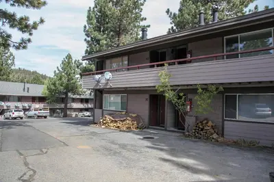 a building with a pile of wood on the side of it at Sierra Manors 8 Townhouse in Mammoth Lakes
