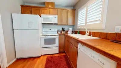 a kitchen with white appliances and wooden cabinets at Sierra Manors 8 Townhouse in Mammoth Lakes