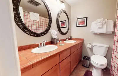 a bathroom with two sinks and a mirror at Sierra Manors 8 Townhouse in Mammoth Lakes