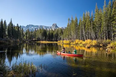 two people in a red canoe on a lake at Courchevel 14 Condo in Mammoth Lakes