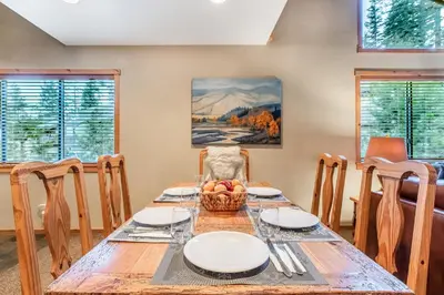 a dining room with a wooden table and chairs at Courchevel 14 Condo in Mammoth Lakes