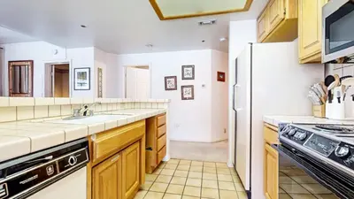 a kitchen with a sink and a refrigerator at Silver Bear 18 Condo in Mammoth Lakes