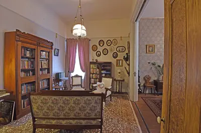a living room with a table and chairs and a room with a dining room at B Street House Inn in Virginia City