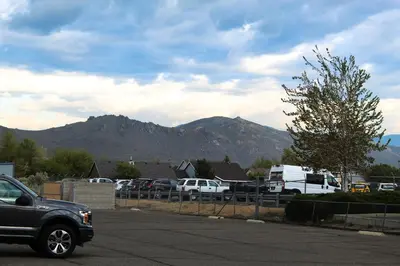 a truck parked in a parking lot with mountains in the background at Super 8 by Wyndham Carson City Lake Tahoe in Carson City