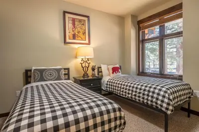 two beds in a room with a window at Solstice 6 in Mammoth Lakes