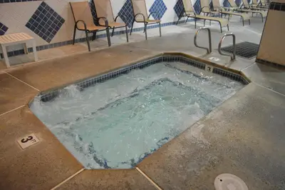 a pool of water with chairs and a table at Cedar Lodge in El Portal