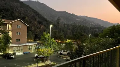 a view of a parking lot with a mountain at Yosemite View Lodge in El Portal