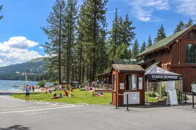 a group of people sitting on the grass near a lake at Ski View Majesty in Truckee