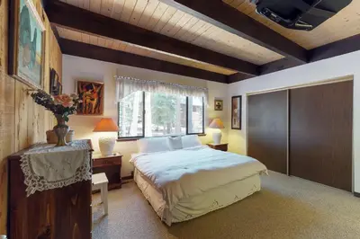 a bedroom with a large bed and a window at Ski View Majesty in Truckee