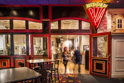 a restaurant with tables and people walking inside of it at Eldorado Reno, A Caesars Destination in Reno