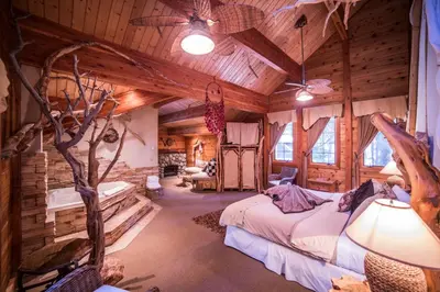 a bedroom in a log cabin with a bed at Cottage Inn At Lake Tahoe in Tahoe City