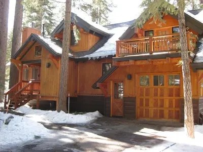 a large wooden house with snow on the ground at 824 Beaver Pond in Truckee