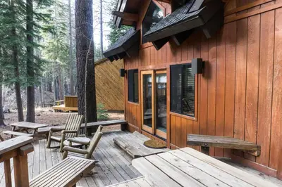 a wooden cabin with benches on a deck at 824 Beaver Pond in Truckee