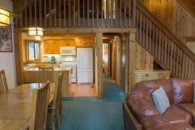 a living room and kitchen in a log cabin at 824 Beaver Pond in Truckee