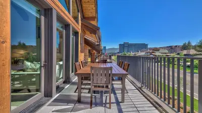 a patio with a wooden table and chairs on a balcony at Zalanta 317 in South Lake Tahoe