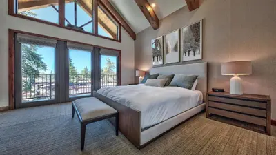 a bedroom with a large bed and a table with a lamp at Zalanta 317 in South Lake Tahoe