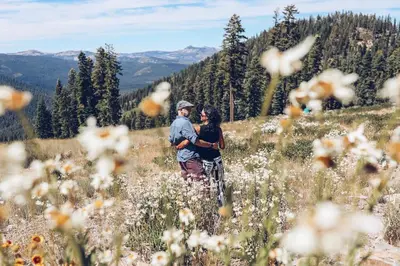 a man and woman standing in a field of flowers at Ski Trails 4042 in Truckee
