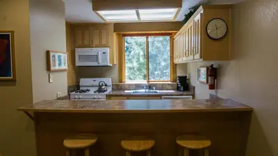 a kitchen with a counter and a sink and a window at Gold Bend 5022 in Truckee