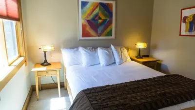 a bedroom with a bed and two tables with lamps at Gold Bend 5022 in Truckee