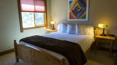 a bedroom with a large bed with two tables and two lamps at Gold Bend 5022 in Truckee