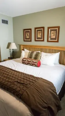 a bedroom with a large bed with white sheets and pillows at Aspen Grove 3090 in Truckee