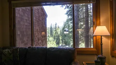 a living room with a couch and a large window at Ski Trails 4024 in Truckee