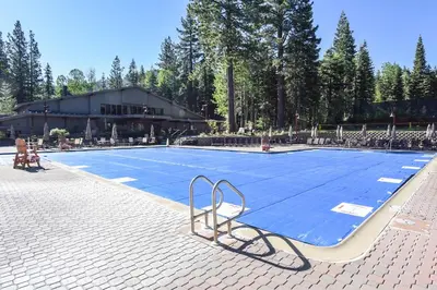 a swimming pool with a blue in front of a building at Ski Trails 4024 in Truckee