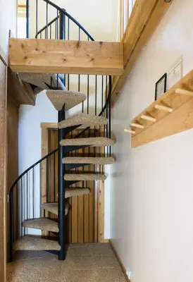a spiral staircase in a house with wooden ceilings at Ski Trails 4024 in Truckee