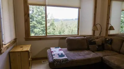 a living room with a couch and a large window at Ski Trails 4070 in Truckee