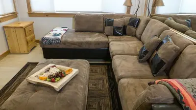 a living room with a couch with a tray of food on it at Ski Trails 4070 in Truckee