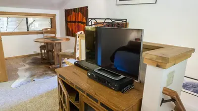 a flat screen tv sitting on top of a wooden entertainment center at Ski Trails 4058 in Truckee