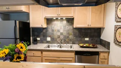 a kitchen with a sink and a refrigerator at Ski Trails 4113 in Truckee