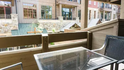 a balcony with a glass table and chairs on a patio at Northstar Village 216 in Truckee