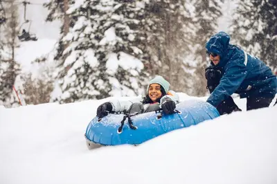 a man is riding on a snowboard in the snow at Northstar Village 237 in Truckee