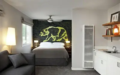 a bedroom with a bed with a painting on the wall at Basecamp Tahoe South in South Lake Tahoe