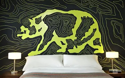 a bedroom with a green and yellow mural on a wall at Basecamp Tahoe South in South Lake Tahoe