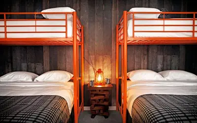 a bedroom with two bunk beds and a lamp at Basecamp Tahoe South in South Lake Tahoe