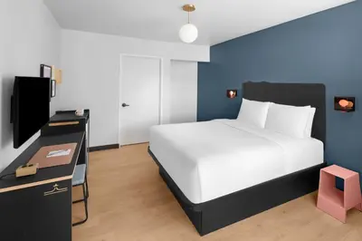 a bedroom with a white bed and a television at evo Hotel Tahoe City in Tahoe City