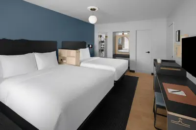 a bedroom with a large white bed and a desk at evo Hotel Tahoe City in Tahoe City
