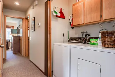 a kitchen with a white counter top and wooden cabinets at Snowcreek IV 598 in Mammoth Lakes