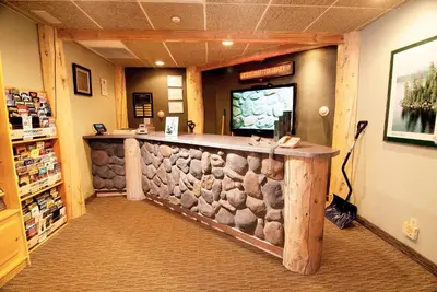 a bar in a pharmacy with a rock wall at The Ridge Sierra in Stateline