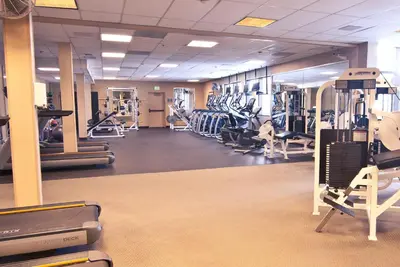 a gym with rows of treadmills and exercise machines at The Ridge Sierra in Stateline