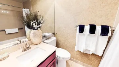 a bathroom with a toilet and a vase of flowers at Tahoe Chaparral in Incline Village