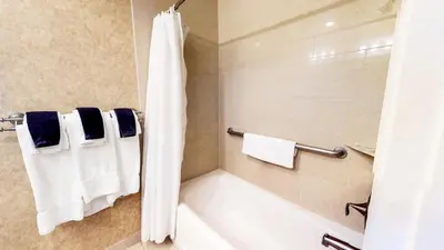 a bathroom with a tub and a shower with towels at Tahoe Chaparral in Incline Village
