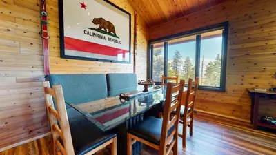 a dining room with a table and chairs in a cabin at Bridges Townhome #5 Condo in Mammoth Lakes